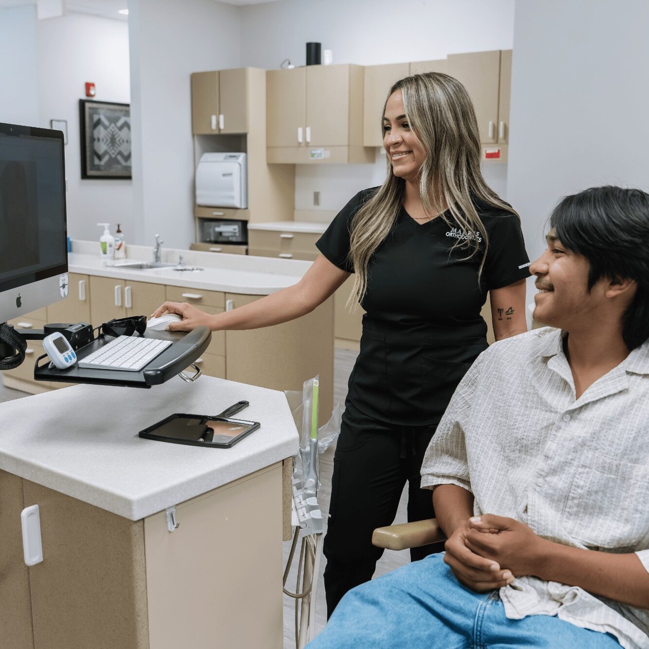 Orthodontic consultation at Marris Orthodontics, staff member assisting patient with digital imaging in modern office setting, showcasing orthodontic care for braces and Invisalign in Orlando.
